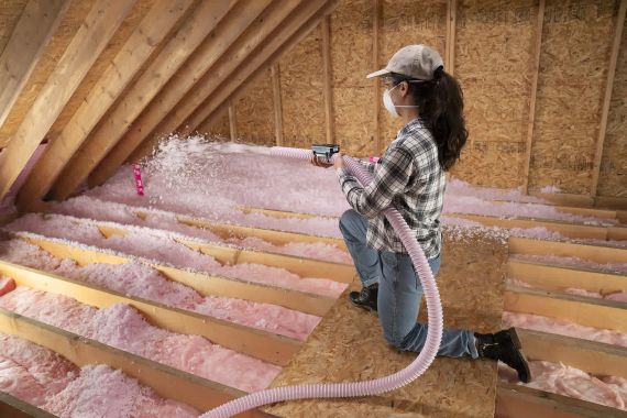 woman blown in attic insulation