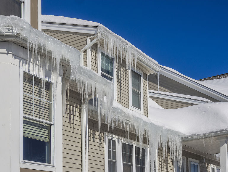 Ice dam on roof causing icicles